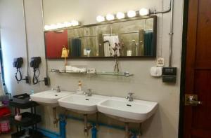 a bathroom with two sinks and a mirror at Bangkok Dreamcatcher hostel in Bangkok