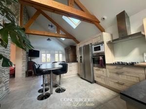 a kitchen with a table and chairs in a room at La croix Luce in Cherbourg en Cotentin