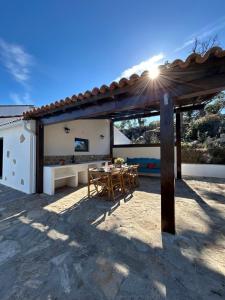 a patio with a table and chairs under a pergola at Casanova Country Villa in Santo António das Areias