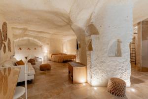 a large living room with a stone wall at Il Belvedere in Matera