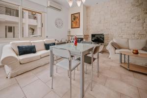 a living room with a table and a couch at K&F Apt in the center of Ierapetra by Hospi in Ierápetra
