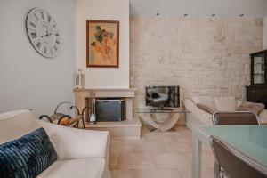 a living room with a couch and a tv at K&F Apt in the center of Ierapetra by Hospi in Ierápetra