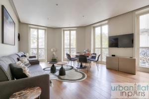 a living room with a couch and a table at 60-LUXURY PARISIAN HOME SEBASTOPOL (2DG) in Paris