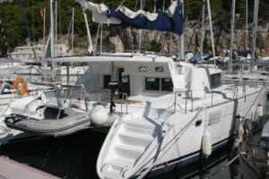 a white boat is docked in a harbor at Chardonnay in Trogir