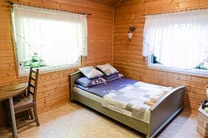 a bedroom with a bed in a wooden room at Domek Letniskowy Pucka in Mieroszyno