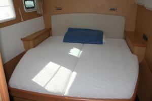 a small bed with a blue pillow on top of it at Chardonnay in Trogir