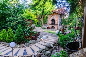 a garden with a pathway and a stone fireplace at Domek Letniskowy Pucka in Mieroszyno