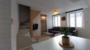 a living room with a couch and a table at Le Scailleteux, petite maison de mineur, climatisée non accessible PMR in Fumay