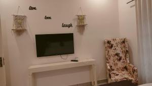a flat screen tv on a wall in a room at Trattorias Holiday Home in Varkala +19 photos