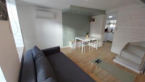 a living room with a couch and a table at Le Scailleteux, petite maison de mineur, climatisée non accessible PMR in Fumay