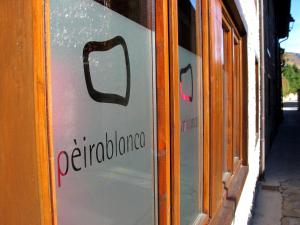 a sign on the side of a store window at Peira Blanca Hotel Gastronómico in Garós