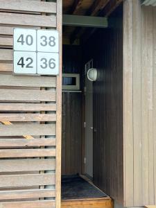 a sign on the side of a building with a door at Kvileskogen 36 in Alta