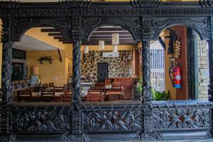 a restaurant with wooden tables and chairs in a building at Pokhara Boutique Hotel in Pokhara
