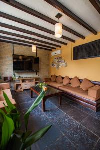 a living room with a couch and a tv at Pokhara Boutique Hotel in Pokhara