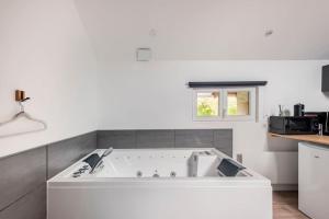 a large white bath tub in a kitchen at Grange Caliana in La Vineuse +53 photos