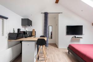a bedroom with a bed and a desk with a computer at Grange Caliana in La Vineuse
