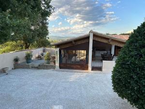 a house with a porch and a patio at La Provence in Maubec