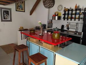 a kitchen with a red counter top in a room at appartement de charme in Bessan