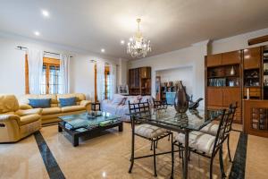 a living room with a couch and a table at Familiar House with Private Pool and Mountains View in Venta Baja