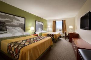 a hotel room with two beds and a flat screen tv at Super 8 by Wyndham Sherwood Park/Edmonton Area in Sherwood Park +37 photos