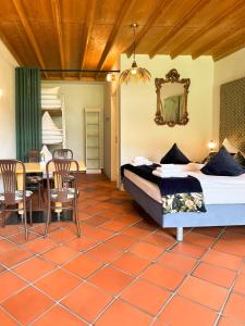 a bedroom with a bed and a table and chairs at Villa Fantasia Budget Boutique Hotel in Füssen