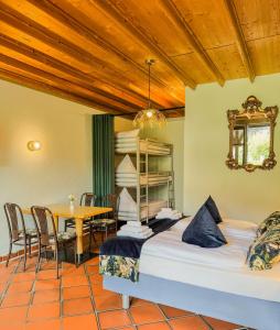 a room with a bed and a table and chairs at Villa Fantasia Budget Boutique Hotel in Füssen