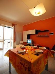 a table with plates on it in a room at Del Rampolino Arancio in Stresa +6 photos