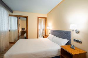 Łóżko lub łóżka w pokoju w obiekcie Hotel Alda Lalín