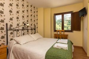 Postel nebo postele na pokoji v ubytování Hotel Rural Somiedo