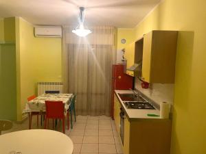 a small kitchen with a table and a dining room at Appartamento Luigi in Alba Adriatica