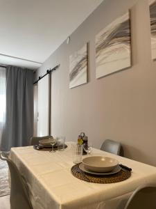 a dining room table with a white table cloth on it at Alojamiento D'Moda in Ribadeo