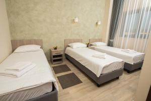 Postel nebo postele na pokoji v ubytování IPN ROOMs