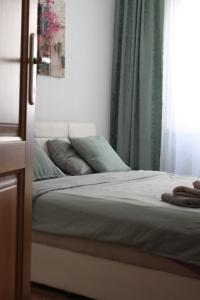 a bed in a room with a window and a bedvisor at Tibra Residence in Sarajevo