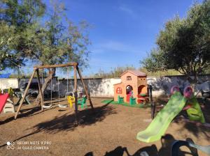 a playground with a slide and a swing set at Appartamento in residence a Campomarino di Maruggio in Maruggio +28 photos