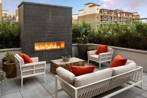 a patio with two chairs and a fireplace at Redwood City 1BR w Gym WD nr Caltrain SFO-918 in Redwood City