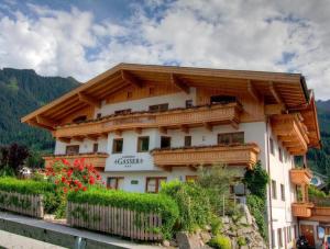 a building with wooden balconies on a mountain at Landhaus Gasser in Mayrhofen