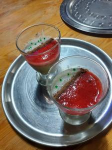 a plate with two bowls of jam and a sandwich at Tigmi Bulbul in Id AÃ¯ssa