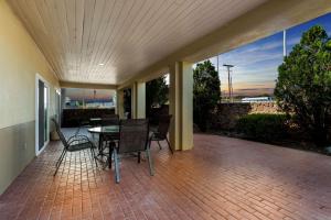 a large patio with a table and chairs on it at Comfort Inn & Suites I-25 near Spaceport America in Truth or Consequences