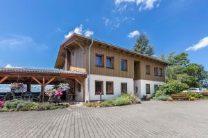 a large building with a pavilion in front of it at PAPPELHOF Landurlaub mit Panoramablick - Motorradunterkunft Fahrradunterkunft in Bad Bellingen