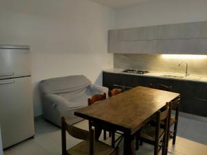 a kitchen with a table and a kitchen with a sink at Casa l'Apuccia in Lettomanoppello