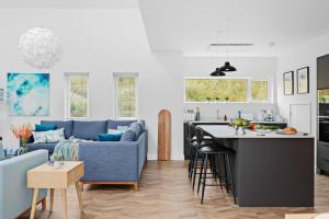 a kitchen and a living room with a couch and a table at No 5 The Vista, Willingcott, Woolacombe in Woolacombe