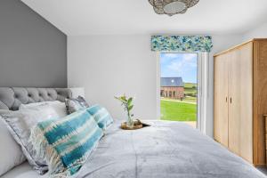 a bedroom with a bed and a large window at No 5 The Vista, Willingcott, Woolacombe in Woolacombe +31 photos