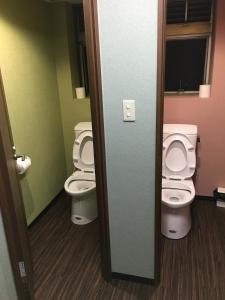 a bathroom with two toilets in a room at Park Inn in Osaka