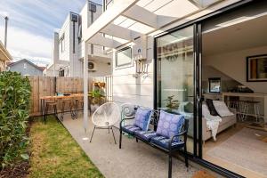 a patio with a couch and a table and chairs at Stunning, modern, two-story detached townhouse in Melbourne