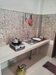 Pondok Giri 3 في جيمباران: طاولة مطبخ مع حوض وموقد