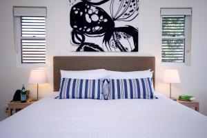 a bed with a white bedspread and pillows at Domain Serviced Apartments in Brisbane