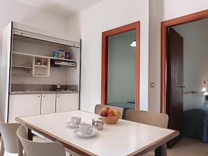 a kitchen and dining room with a table and chairs at Villaggio Turistico La Mantinera - Residence in Praia a Mare