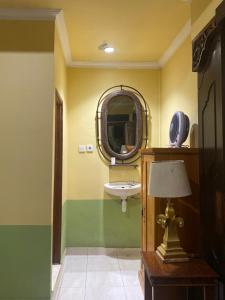 a bathroom with a sink and a mirror at Teras subak Homestay in Jatiluwih