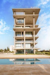 a building with a reflecting pool in front of it at Protaras Eden Seaside Suite in Protaras