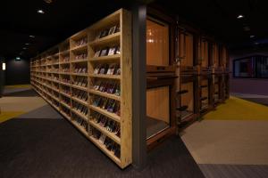 a row of wine tasting racks in a room at Booth Netcafe & Capsule in Tokyo